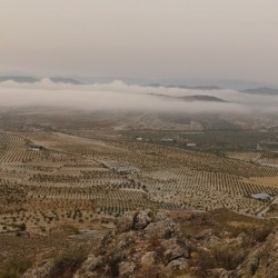 View from Cerro de la Cruz overlooking the land, up above the clouds